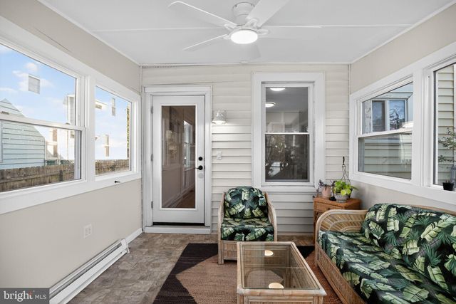 a bedroom with a bed a window and potted plant
