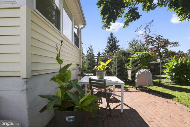 a view of a patio with table and chairs and potted plants