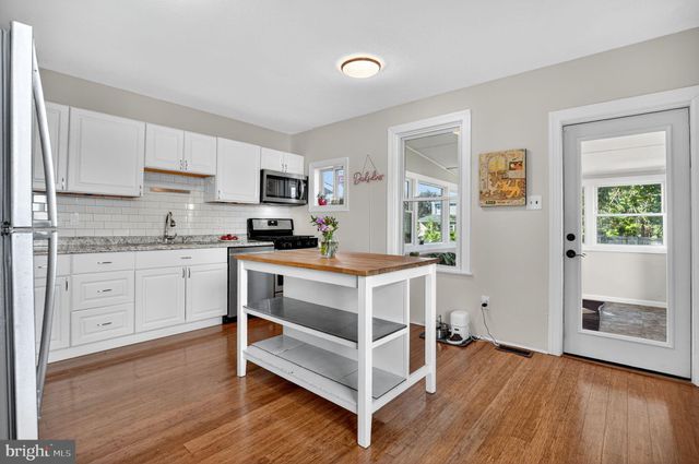 a kitchen with a sink window and cabinets