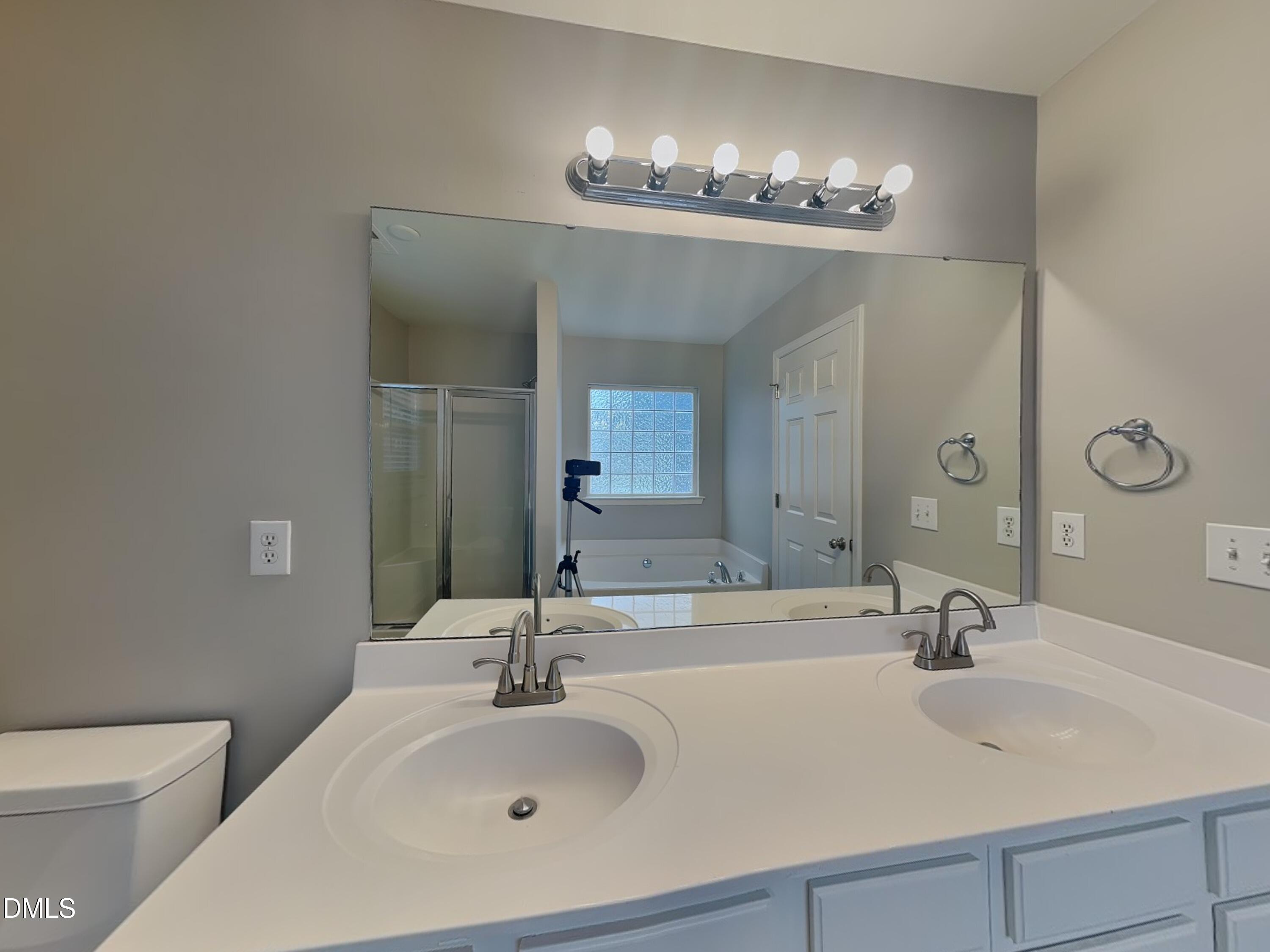 3101 Rendezvous Drive Raleigh, NC 27610 - Photo 11 of 18 a bathroom with a sink double vanity and a mirror