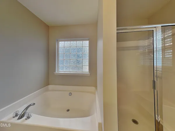 a bathroom with a tub and a shower