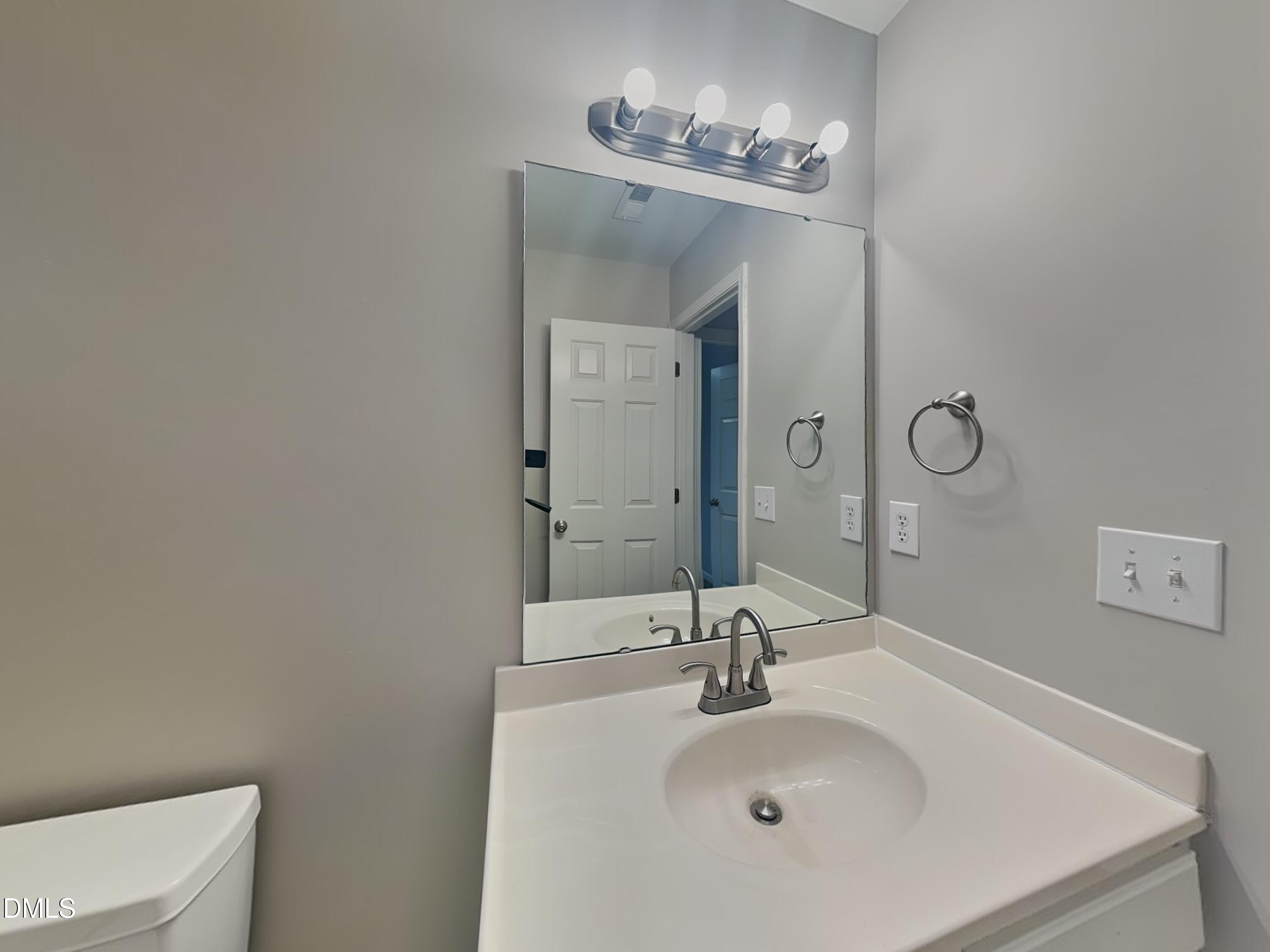 3101 Rendezvous Drive Raleigh, NC 27610 - Photo 15 of 18 a bathroom with a sink and a mirror