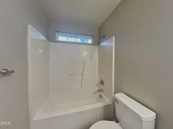 a bathroom with a toilet and a bathtub