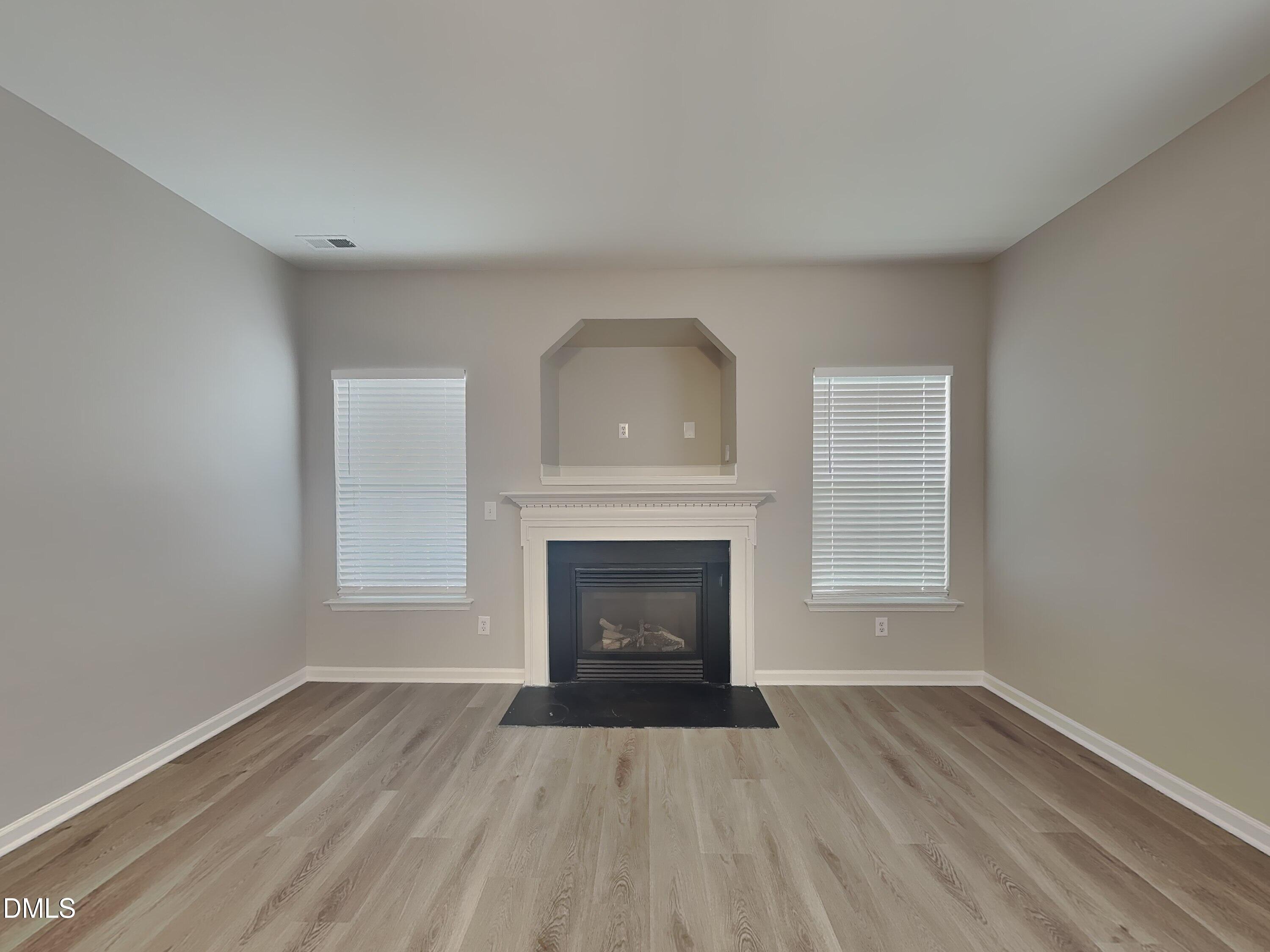 3101 Rendezvous Drive Raleigh, NC 27610 - Photo 3 of 18 a view of an empty room with a fireplace and a window