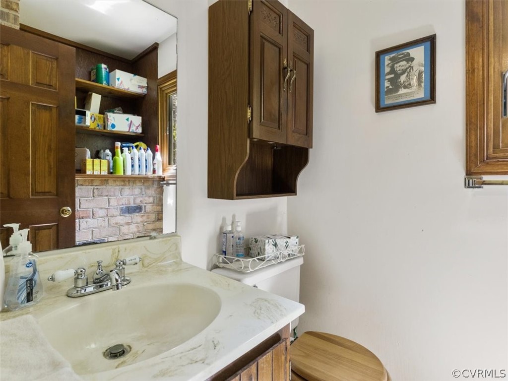 1614 Blakely Road Crozier, VA 23039 - Photo 19 of 33 a bathroom with a sink and a mirror