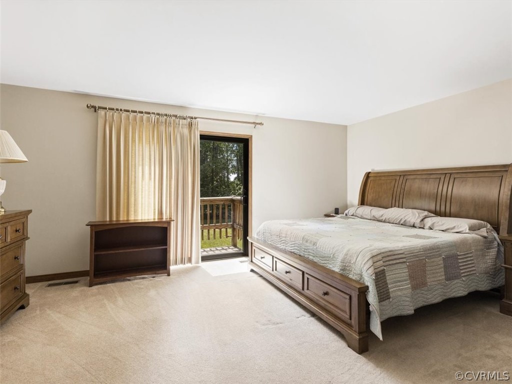 1614 Blakely Road Crozier, VA 23039 - Photo 20 of 33 a spacious bedroom with a bed and a couch