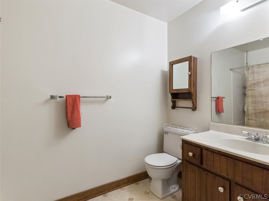 1614 Blakely Road Crozier, VA 23039 - Photo 29 of 33 a bathroom with a sink vanity mirror and toilet