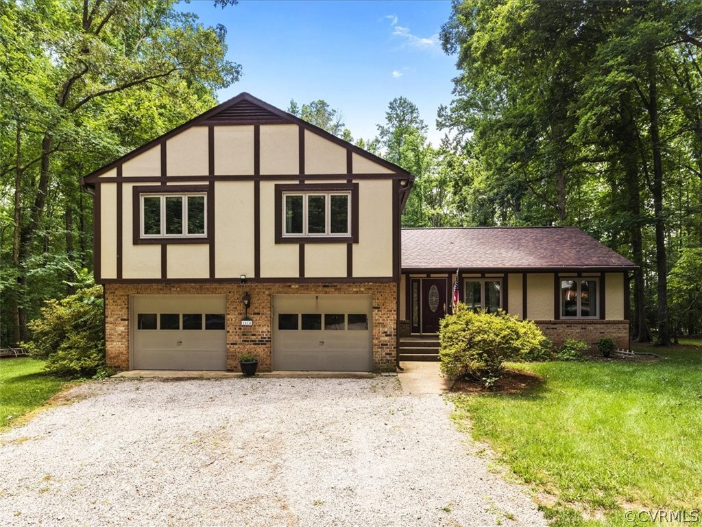 1614 Blakely Road Crozier, VA 23039 - Photo 3 of 33 a front view of a house with a yard and garage