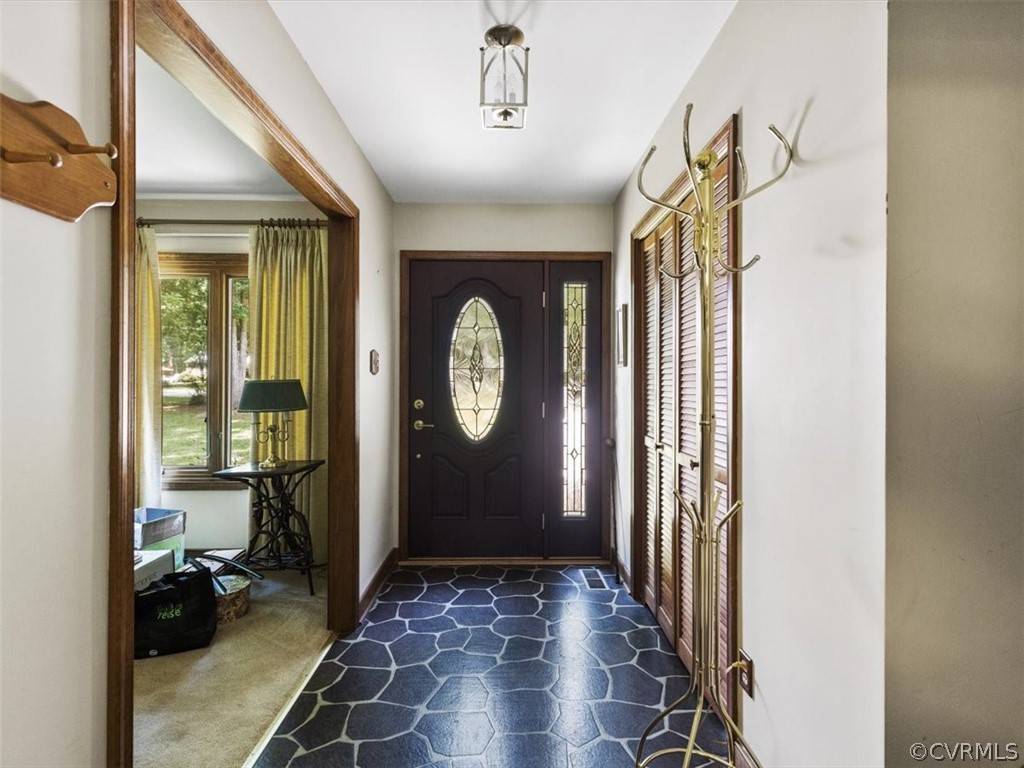 1614 Blakely Road Crozier, VA 23039 - Photo 4 of 33 a view of a hallway with wooden floor and a livingroom with furniture