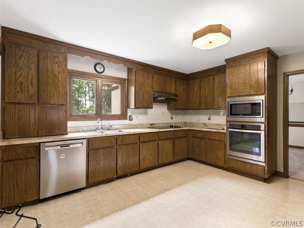 1614 Blakely Road Crozier, VA 23039 - Photo 5 of 33 a kitchen with stainless steel appliances granite countertop a stove sink and cabinets