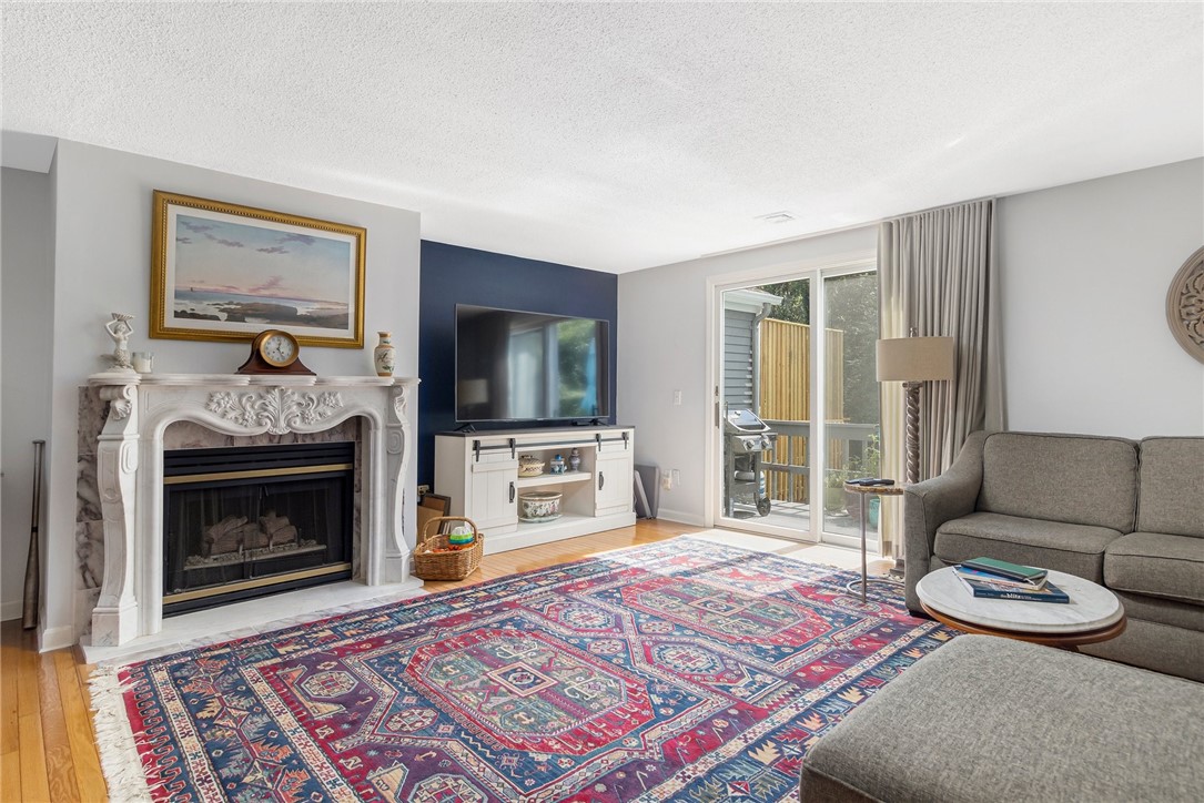 5390 Post Road, Unit 4 East Greenwich, RI 02818 - Photo 3 of 35 Enter into the large living room with a beautiful, marble, gas fireplace.