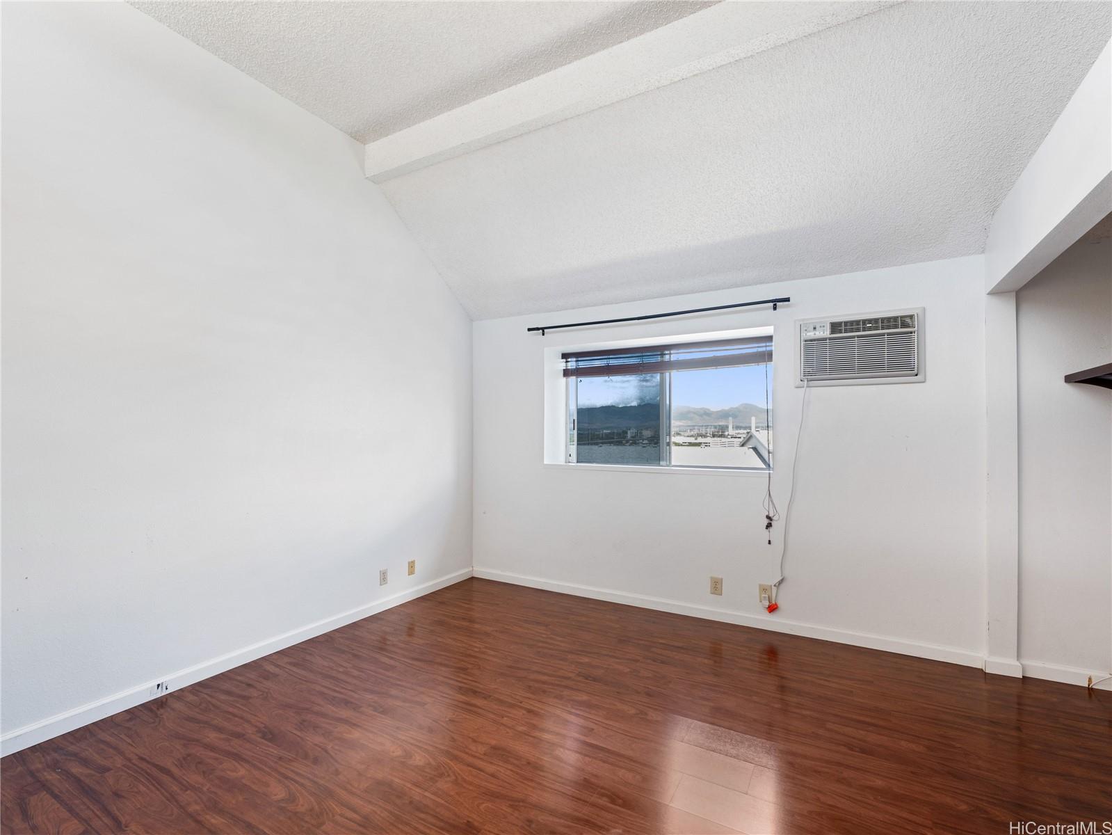 98-941 Moanalua Road, Unit 403 Aiea, HI 96701 - Photo 8 of 25 wooden floor in an empty room