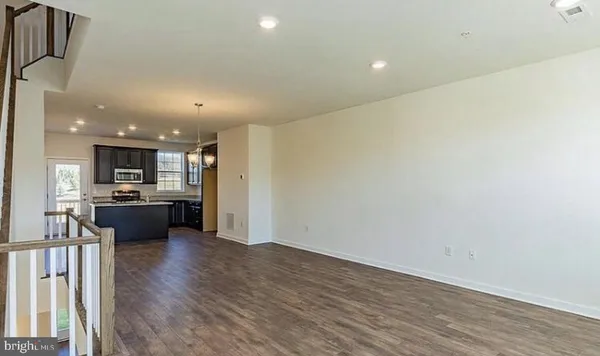 a view of an entryway with wooden floors