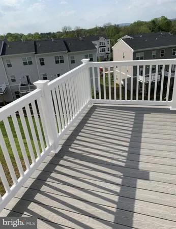a view of a balcony with wooden floor