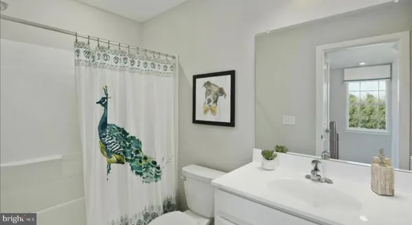 a bathroom with a sink mirror and vanity