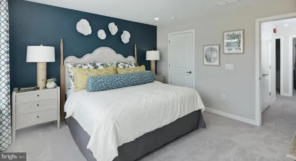 a bedroom with a bed and a lamp