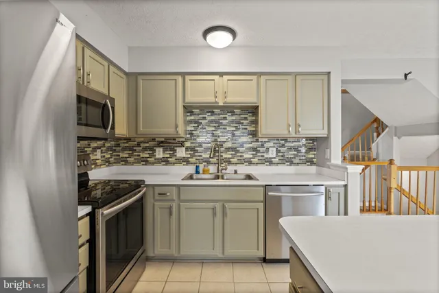 a kitchen with a sink stove and microwave