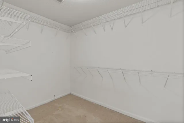 a white toilet next to a bathroom