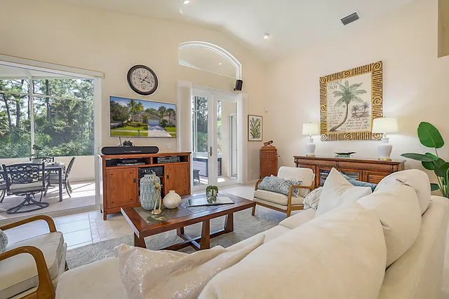 a living room with furniture kitchen and a table