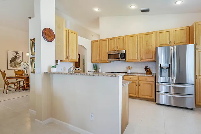 a kitchen with cabinets and chairs
