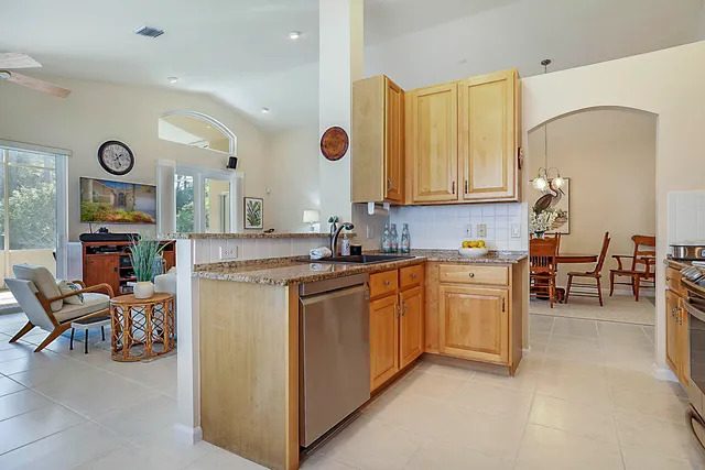 a kitchen with stainless steel appliances granite countertop a stove microwave and refrigerator