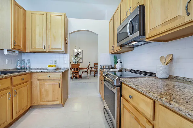 a bedroom with a bed and a dresser with mirror