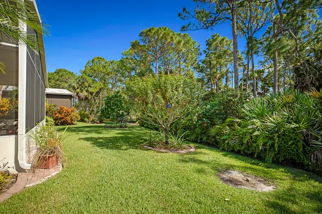 a living room with furniture and floor to ceiling windows