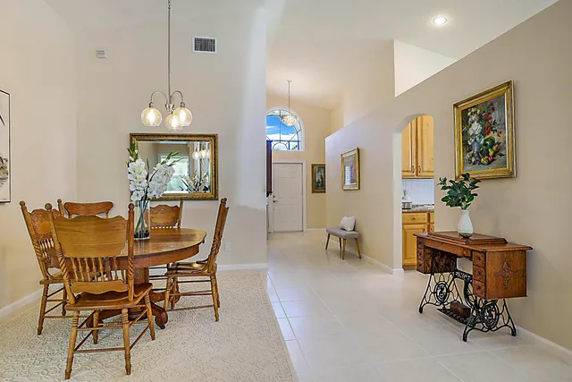 a view of a dining room with furniture and a chandelier