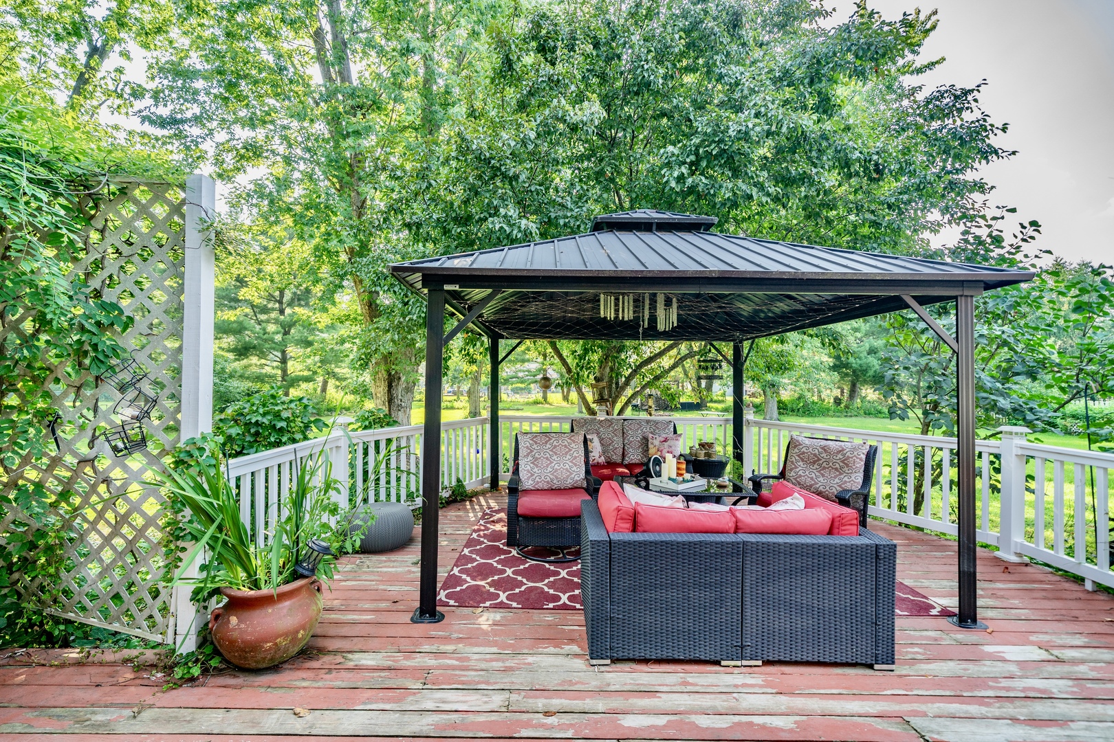 9817 North Hunters Lane Spring Grove, IL 60081 - Photo 60 of 73 a view of deck with table and chairs under an umbrella with wooden floor