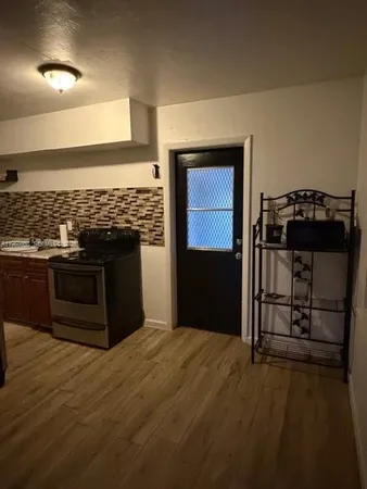 a kitchen with stainless steel appliances granite countertop a stove and a refrigerator