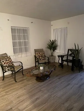 a living room with furniture and a potted plant