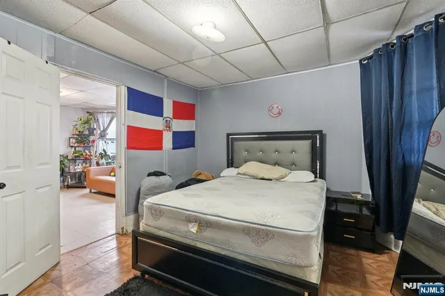 a bedroom with bed and a flat tv screen