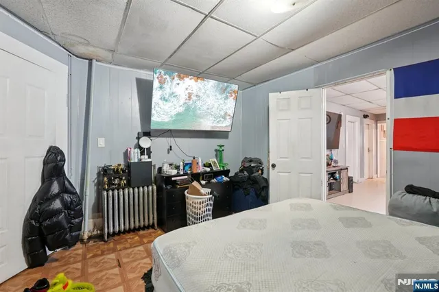 a bedroom with a bed and a large window