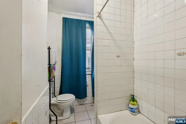 an empty room with wooden floor and a window