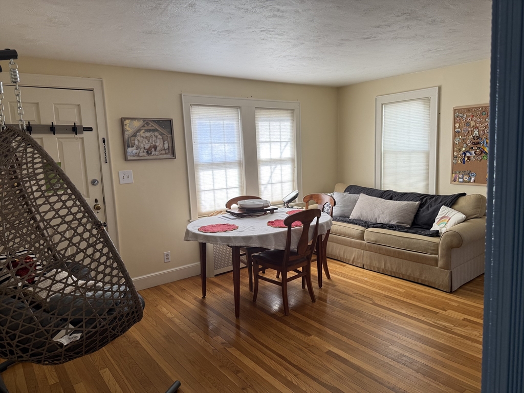 45 McPhee Road, Unit 1 Framingham, MA 01701 - Photo 2 of 11 a living room with furniture and a wooden floor