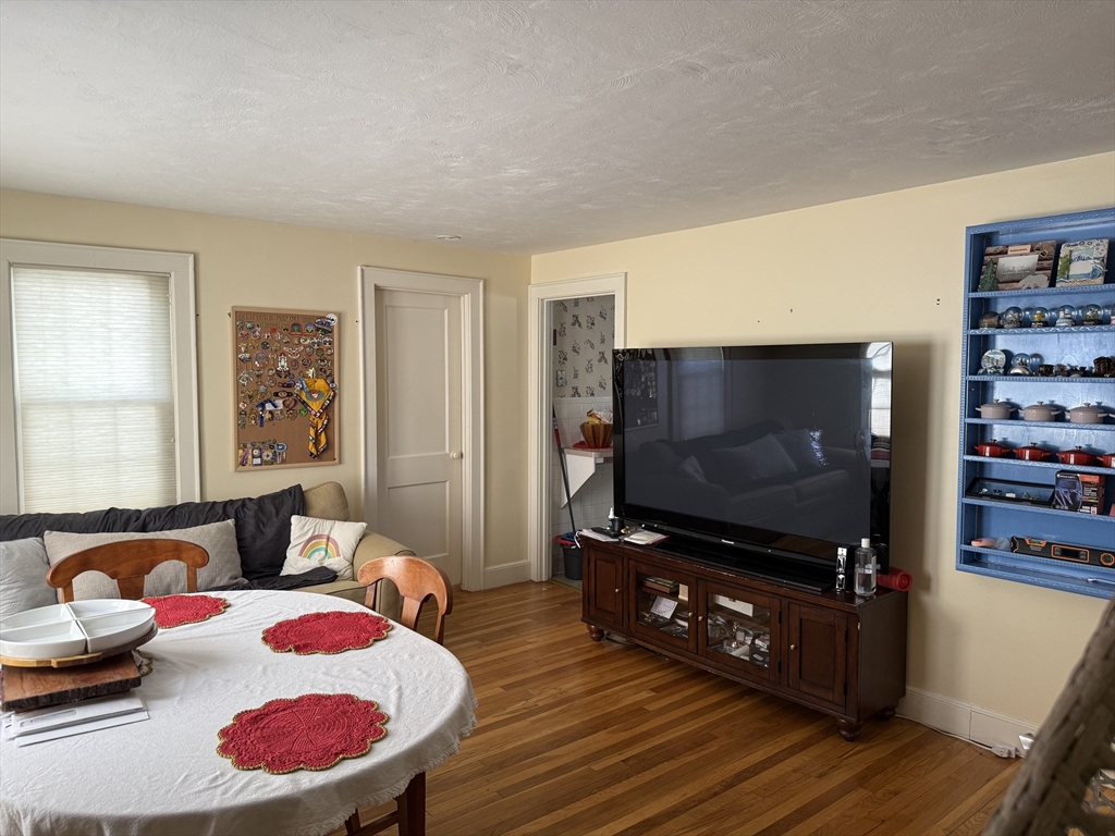 45 McPhee Road, Unit 1 Framingham, MA 01701 - Photo 3 of 11 a living room with furniture and a flat screen tv