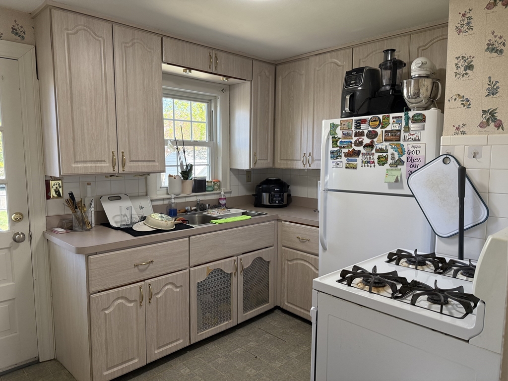 45 McPhee Road, Unit 1 Framingham, MA 01701 - Photo 5 of 11 a kitchen with a sink stove and cabinets
