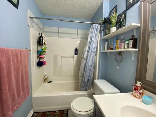 a bathroom with a sink mirror and toilet