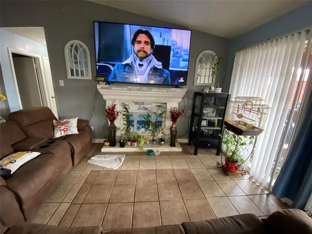 a kitchen with a dining table chairs and view of living room