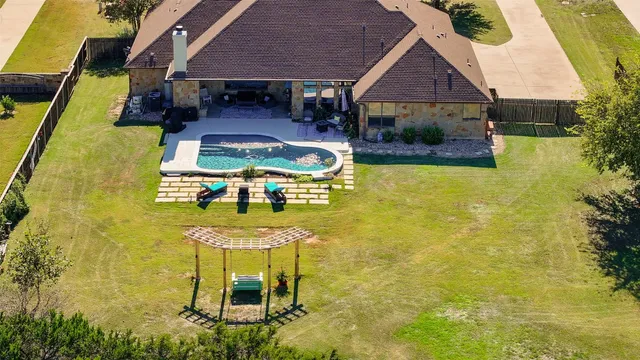 a swimming pool with table and chairs