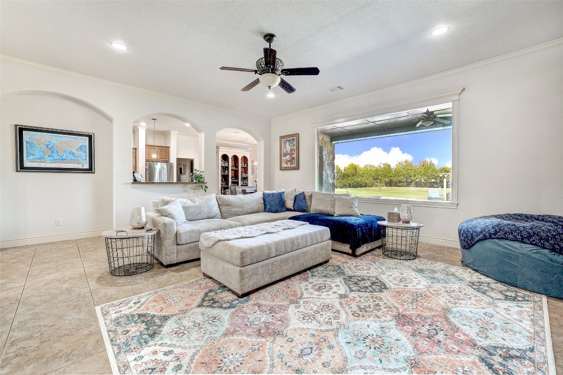 Undisclosed Address Georgetown, TX 78633 - Photo 11 of 38 Living area featuring arched walkways and ceiling fan