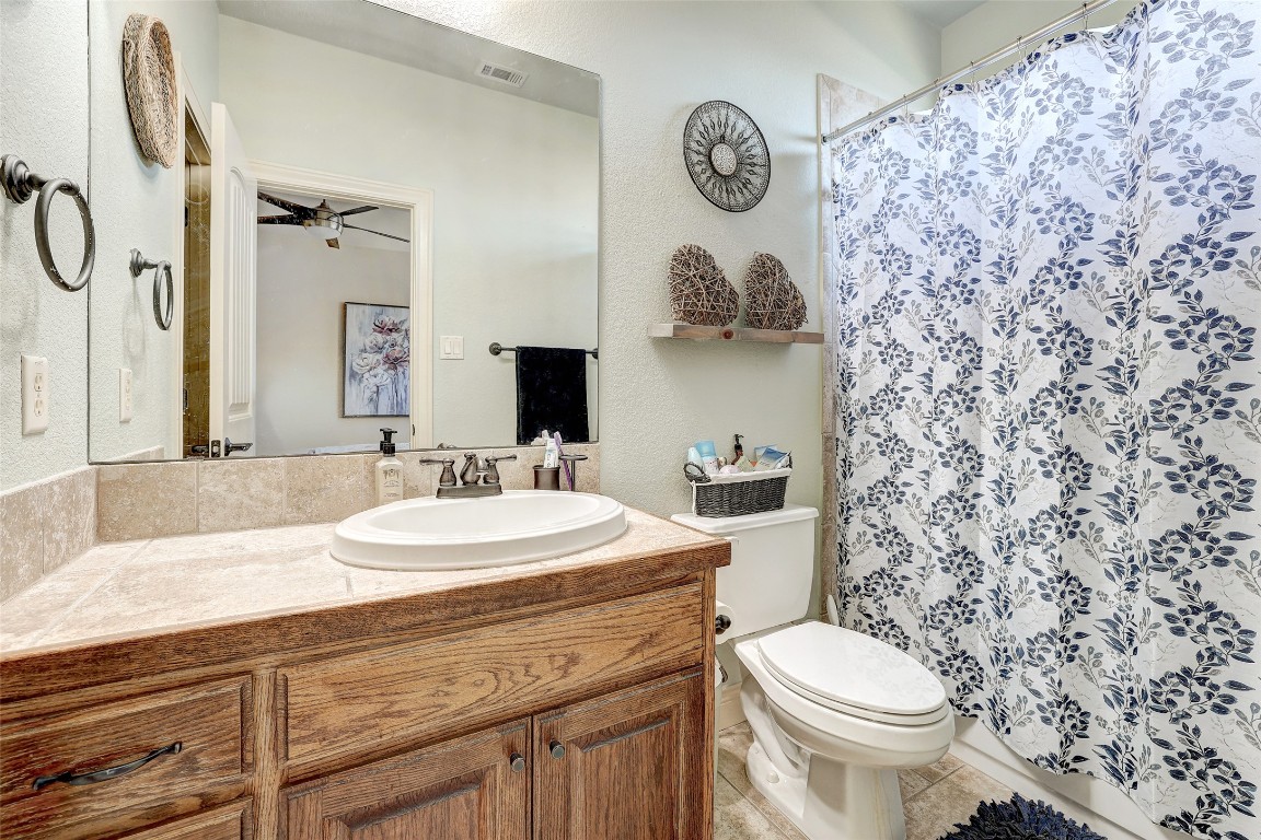 Undisclosed Address Georgetown, TX 78633 - Photo 24 of 38 Bathroom featuring vanity, a shower with curtain, and light tile patterned flooring
