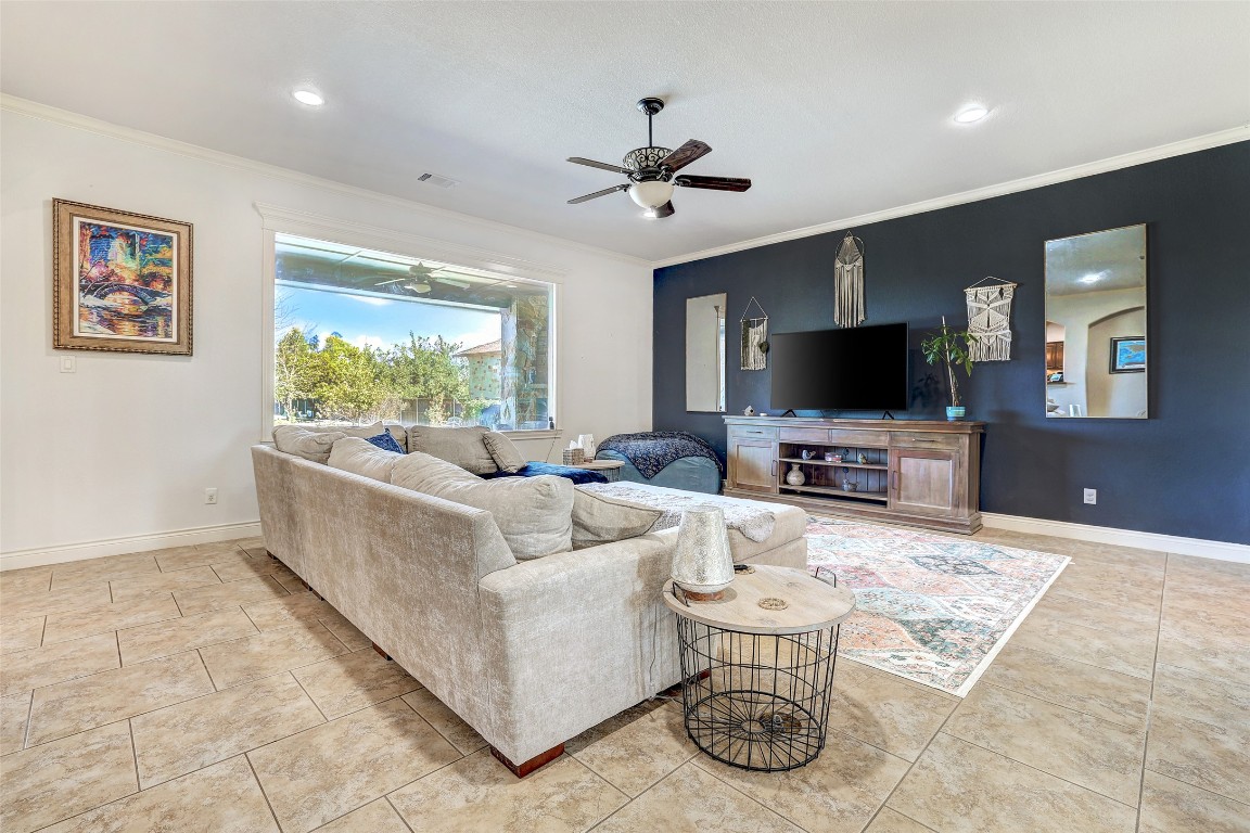 Undisclosed Address Georgetown, TX 78633 - Photo 10 of 38 Living area with ornamental molding, a ceiling fan, recessed lighting, and light tile patterned floors