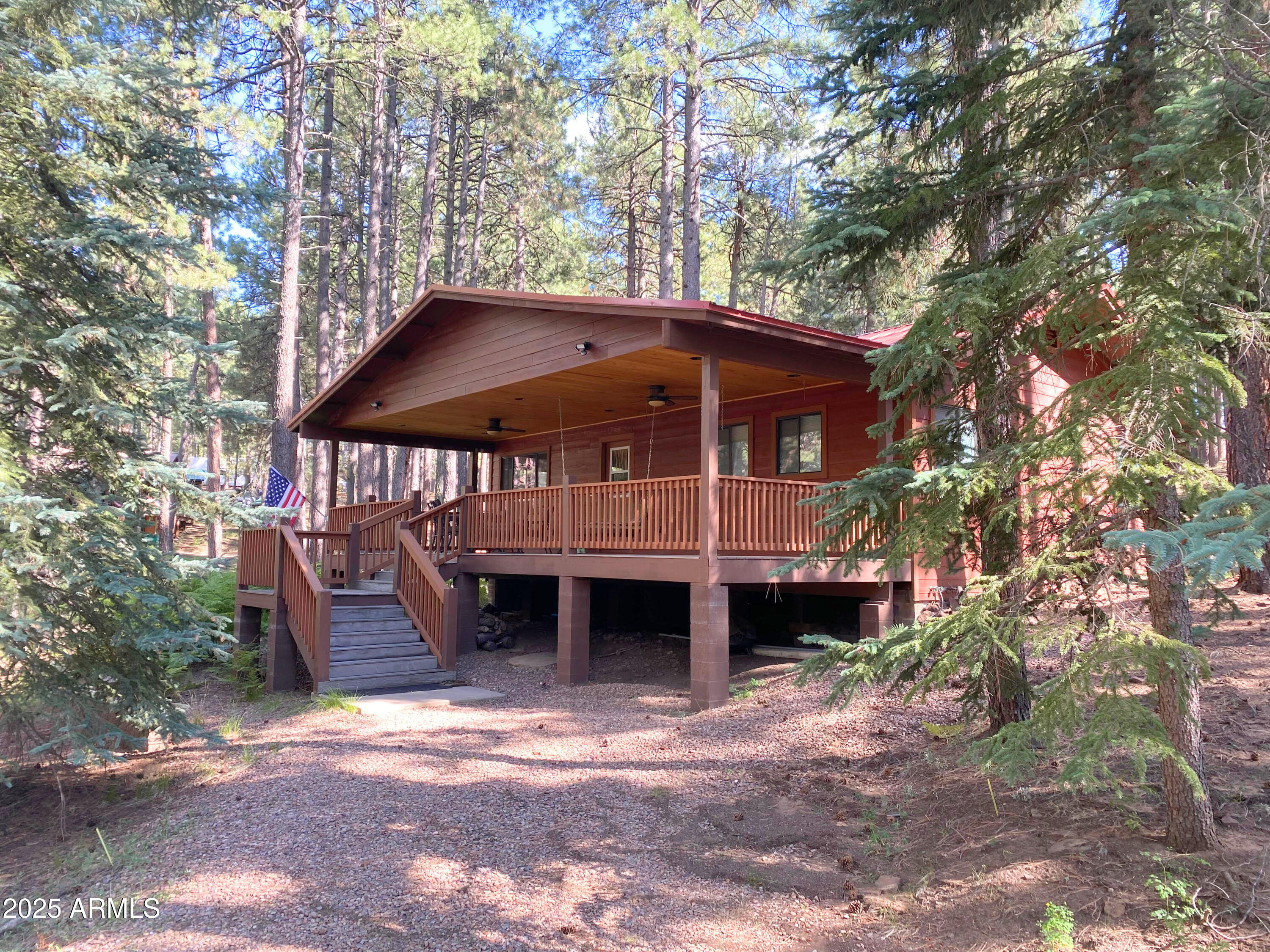a view of a house with large trees and a yard