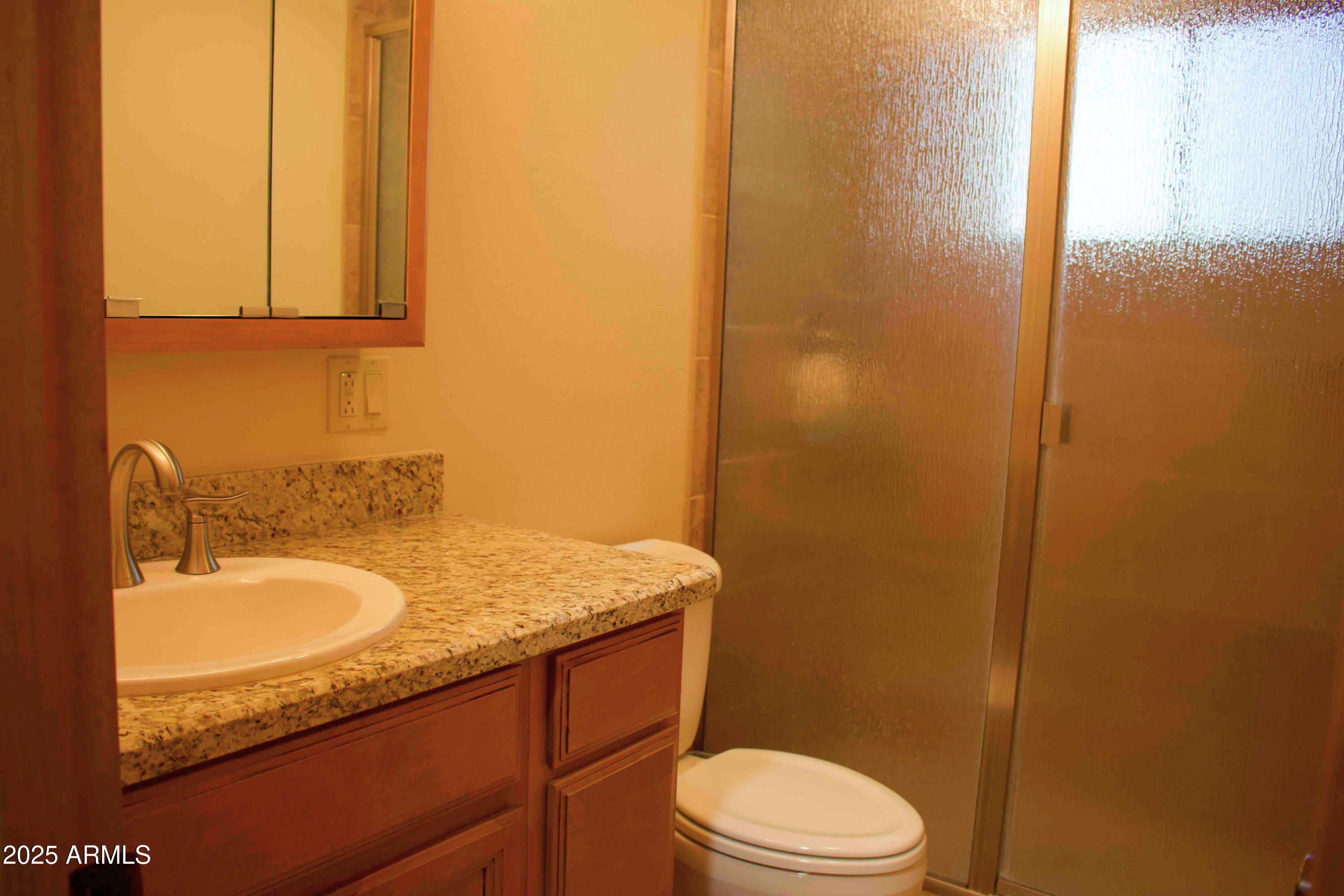 2592 Tom Loop Forest Lakes, AZ 85931 - Photo 14 of 25 a bathroom with a granite countertop sink toilet and mirror