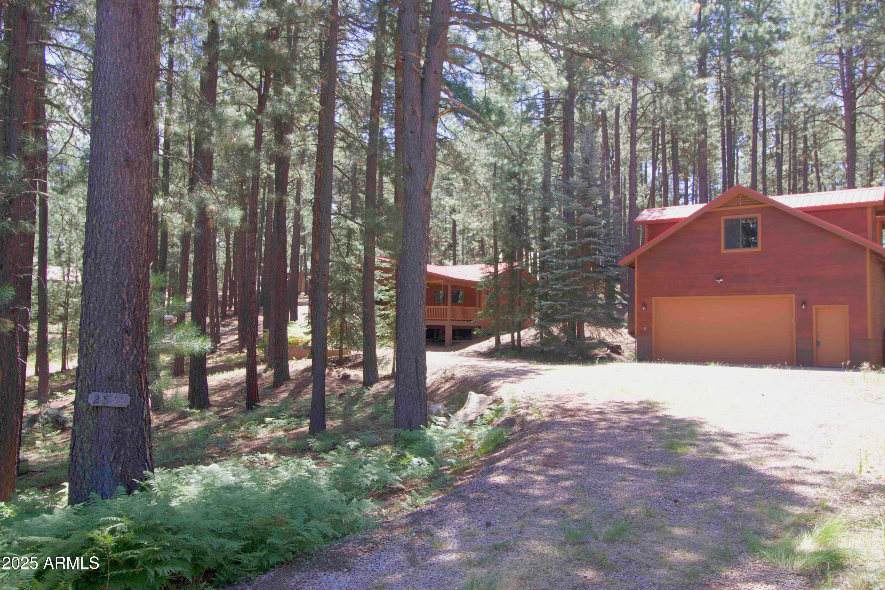 2592 Tom Loop Forest Lakes, AZ 85931 - Photo 2 of 25 a front view of a house with a yard and tree s