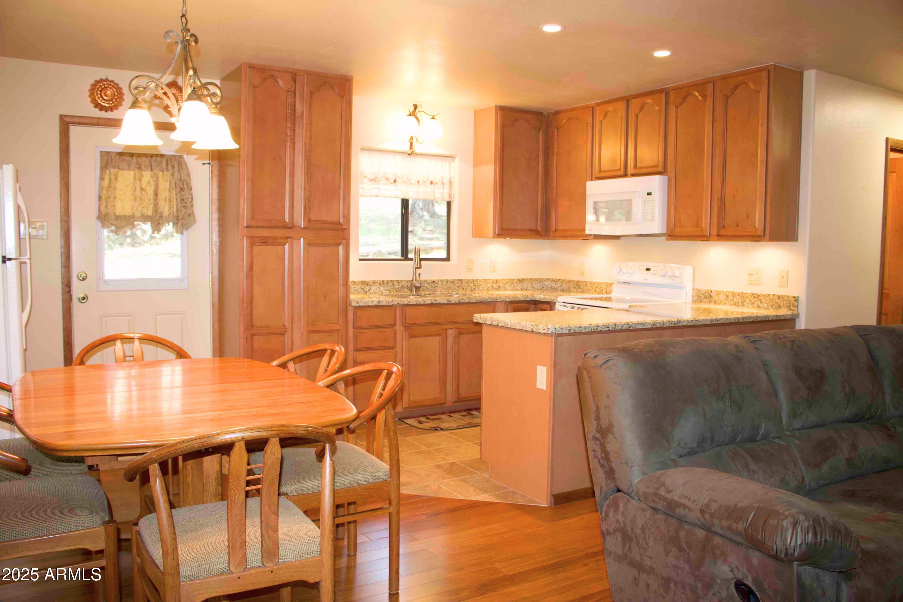 2592 Tom Loop Forest Lakes, AZ 85931 - Photo 4 of 25 a kitchen with stainless steel appliances granite countertop a table chairs and a refrigerator
