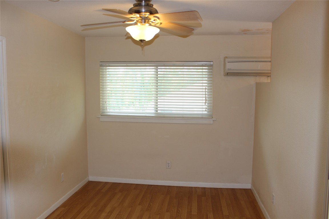304 East 33rd Street, Unit 19 Austin, TX 78705 - Photo 10 of 15 wooden floor in an empty room with a window