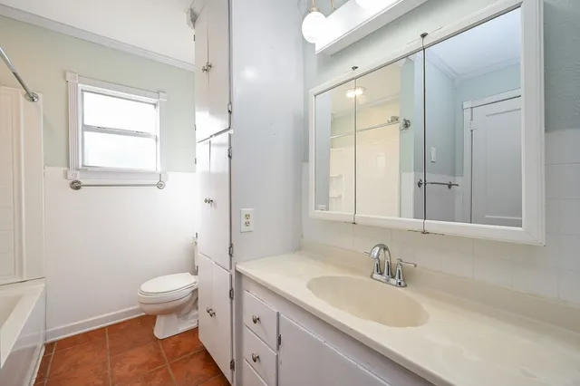 a bathroom with a sink a toilet and a mirror