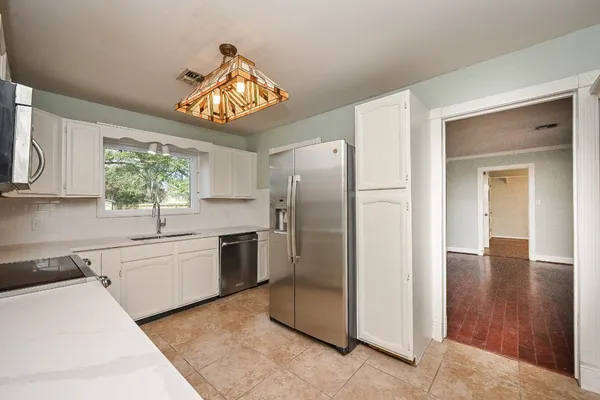 a kitchen with a sink cabinets and window